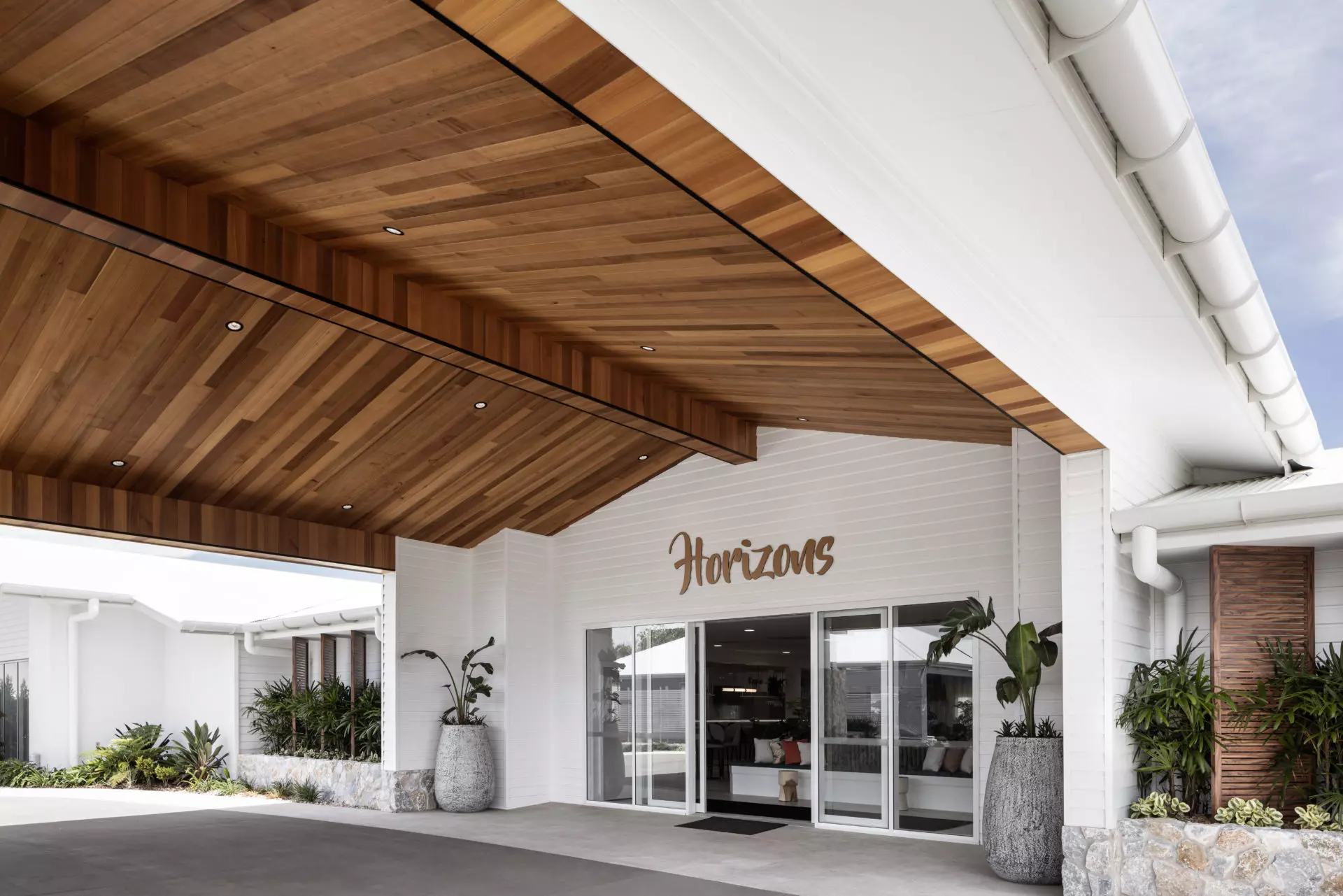 Palm Lake Resort Bargara entrance with large glazed doors and windows.