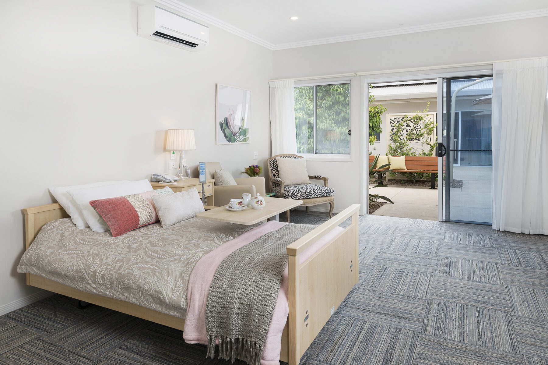 Resident room glazing opening to a sheltered courtyard at Palm Lake Care Bargara.