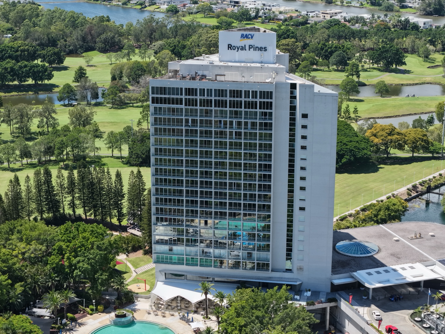 Front aerial view of RACV Royal Pines Resort tower with completed window film visible across the facade.